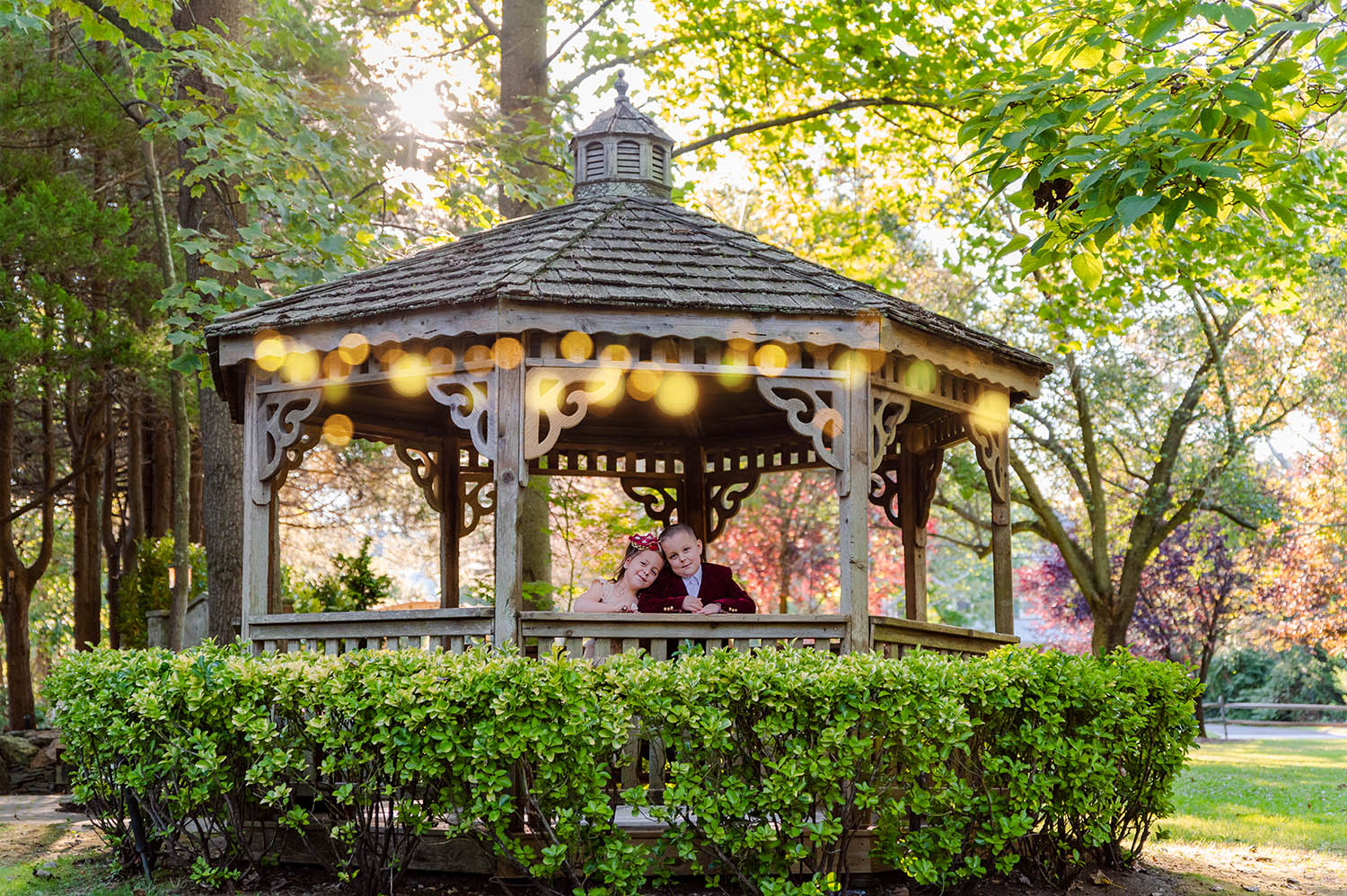 Brother and sister in a gazebo in the fall - Vanessa Guzzo Photography