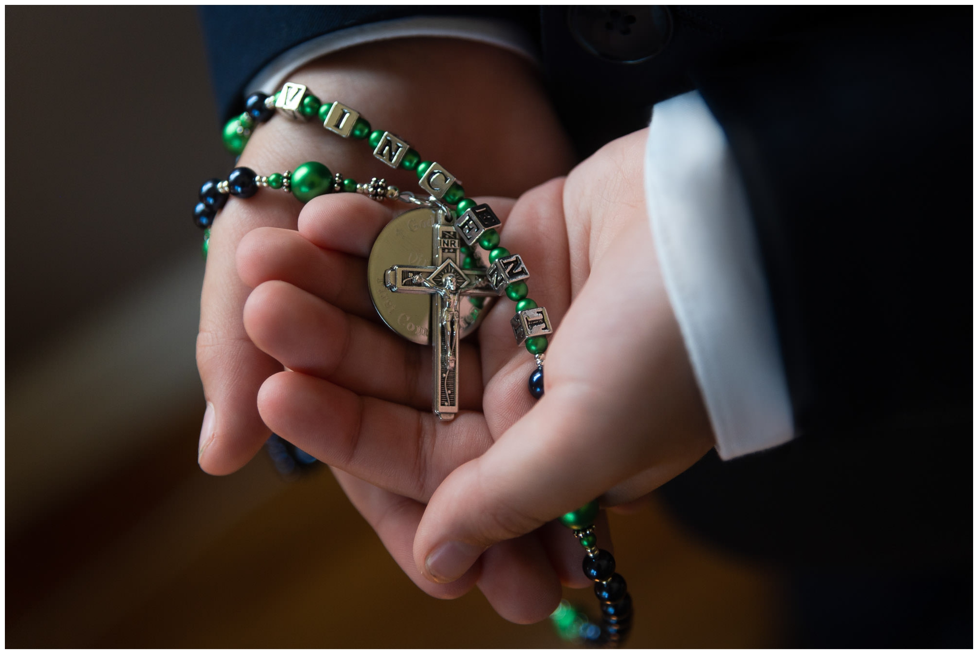 boy holding a rosary for first holy communion